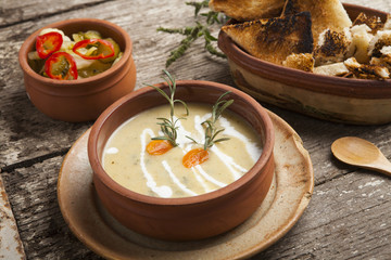 Fresh cream soup in a bowl with bread and seasonal salad