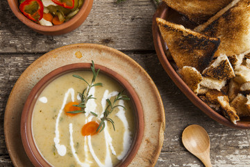 Fresh cream soup in a bowl with bread and seasonal salad