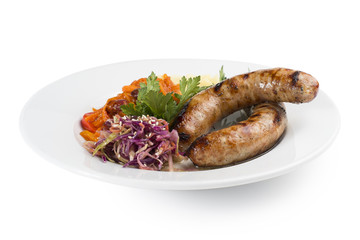 Grilled sausages with potatoes, carrot sauce, and pickled salad