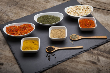 Powder spices on spoons and bowl