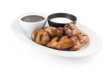 Chicken legs on the grill with soy sauce and sour cream