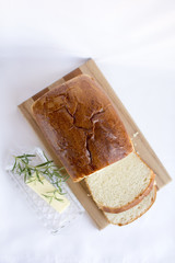 Slices of homemade white bread on wood cutting board