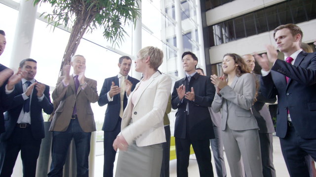  Confident diverse business team applauding their success and shaking hands