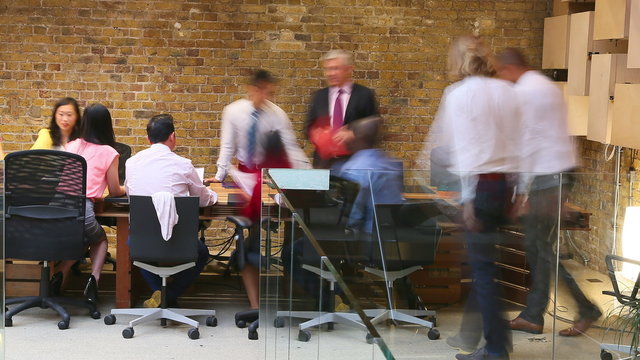  Time lapse of creative mixed ethnicity business team in modern office