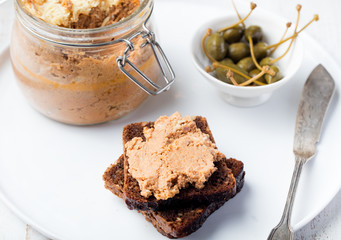 Baked meat pate in jar and on bread Gourmet food