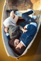 Happy romantic couple rowing a small boat on lake