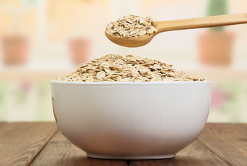 Spoon gaining oatmeal in bowl