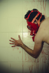 frustration naked man with red gas mask, blood, despair and suic
