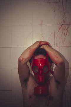 solitude, naked man with red gas mask, blood, despair and suicid