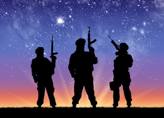 Silhouette of men standing against starry sky at night