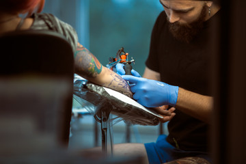 Tattooist makes a tattoo. Closeup