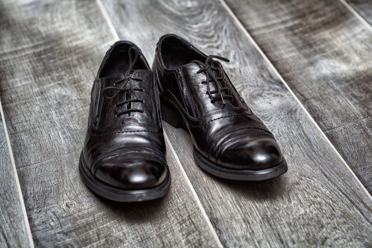 people, business, fashion and footwear concept. Classic black shoes on a wooden background