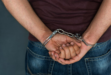 Caucasian male arrested and with handcuffs