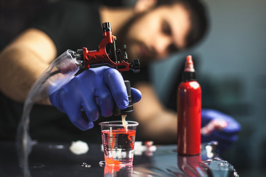 Naklejki Tattooist makes a tattoo. Closeup