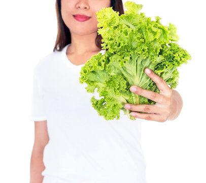 Young woman holding vegetables on white background