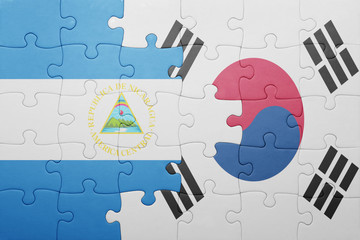 puzzle with the national flag of nicaragua and south korea