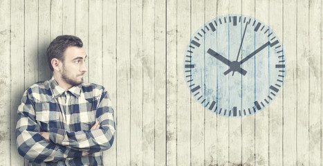 Man looks at a clock