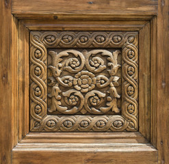 Fototapeta na wymiar fragment of a carved wooden door