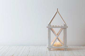 white wooden vintage lantern with burning candle on white backgr