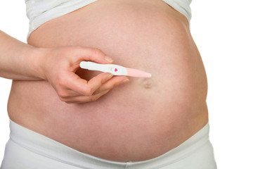 Pregnant woman with pregnancy test