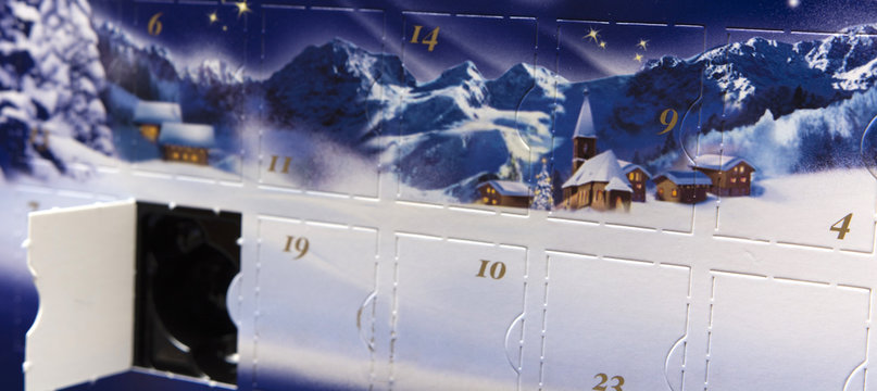 Advent Calendar With An Open Box With A Picture Of Snow And Snow-covered Houses With Mountains In The Background