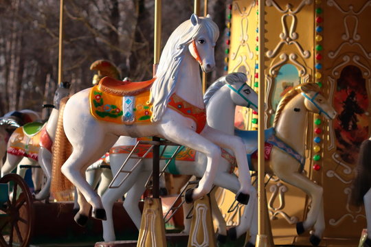 Carousel with horses in City Park in morning sun