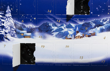 Advent calendar with an open box with a picture of snow and snow-covered houses with mountains in the background