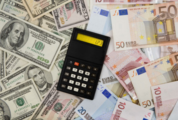 Dollar and euro banknotes background with calculator displaying exchange rate