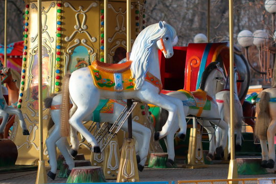 Carousel with horses in City Park in morning sun
