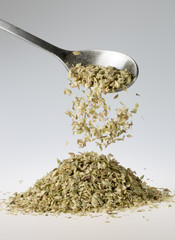 Dried Oregano Falling from Tablespoon