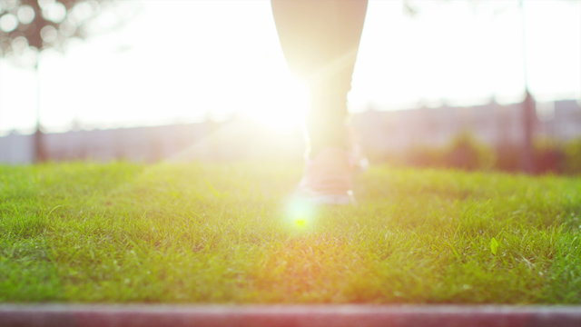  Low angle view of the feet of a female athlete walking through natural environment