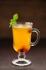 Sea-buckthorn tea with fresh mint on dark background selective f