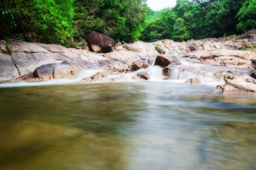 Manora Small Waterfall and rock in tropical forest,Phattalung Province (Un-focus image)