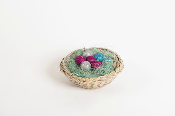 Fototapeta na wymiar Christmas balls lying in a basket in the nest