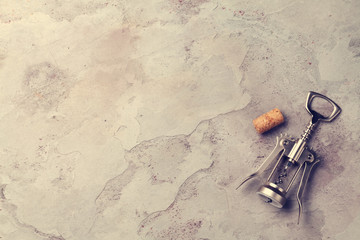 Corkscrew and cork on stone table