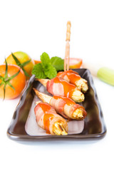 grilled meat with corn on black plate on white background