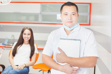 Happy dentist doctor and patient at stomatological clinic