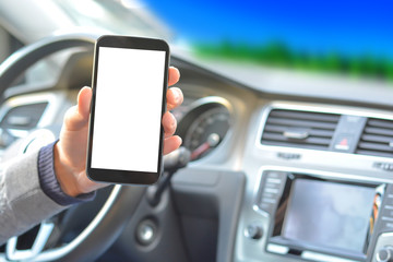 Smartphone hold by man inside a car while driving