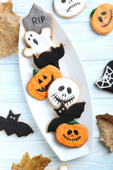 Fresh halloween gingerbread cookies on blue wooden table