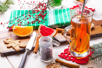 Winter hot drink with spices on wooden table.