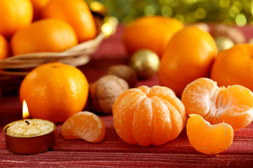 Ripe mandarins on a red wooden table
