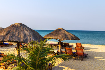beach lounge chairs under tent on beach