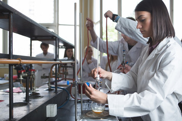 Science students working with chemicals in the lab at the university.Happy student, content for...