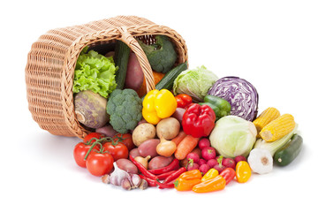 Fresh vegetables next to the overturned basket.