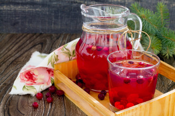 Red cranberry fruit drink, a pitcher and a glass.
