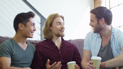 Portrait of young people socialising together and having fun over a coffee