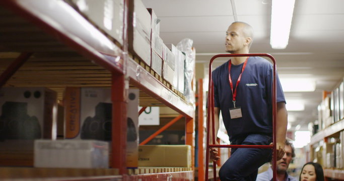 Workers in a warehouse or factory checking stock and preparing deliveries