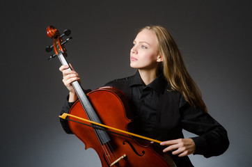 Woman playing classical cello in music concept © Elnur