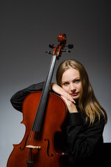Woman playing classical cello in music concept