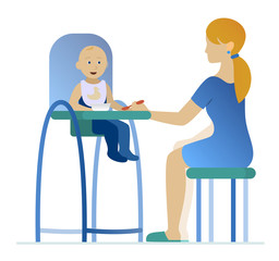 mother feeding a young child in highchair